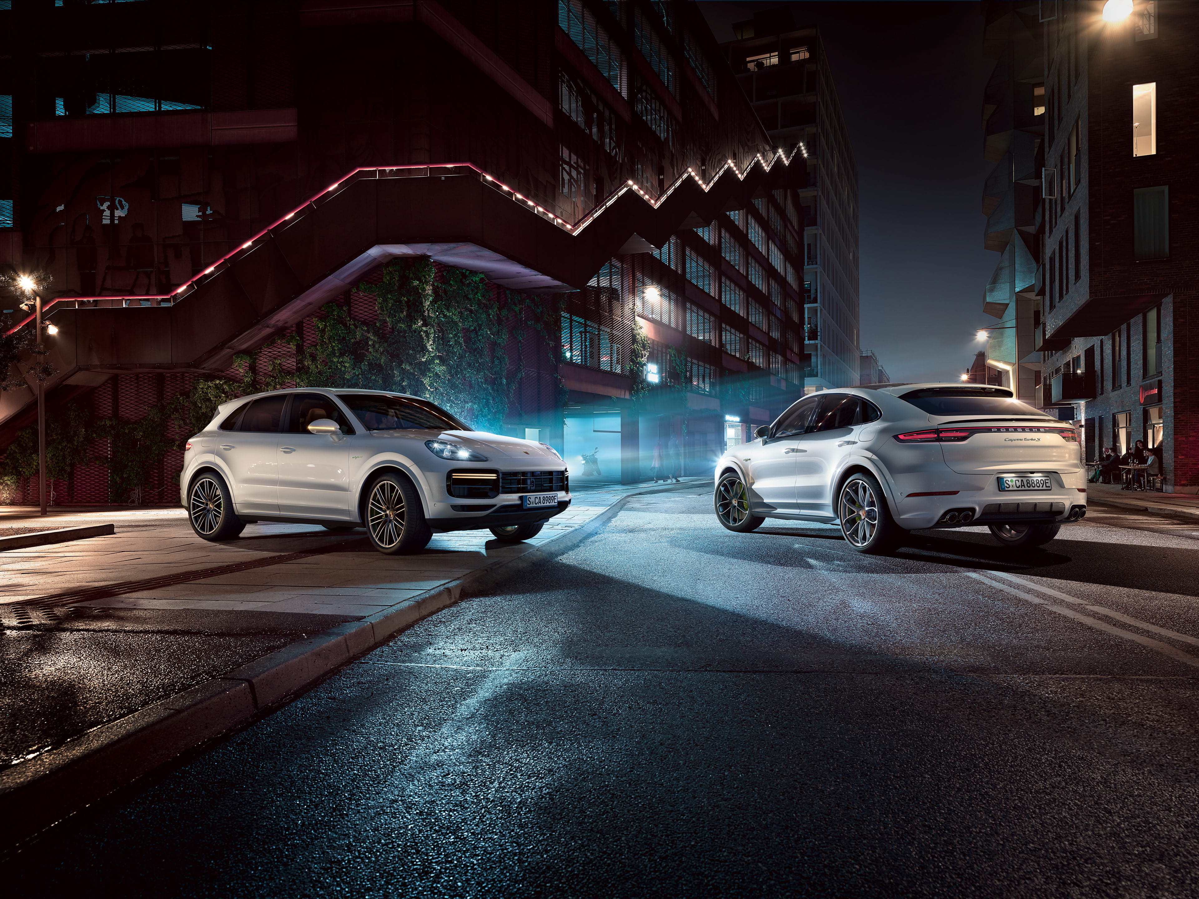 Two white Cayenne models